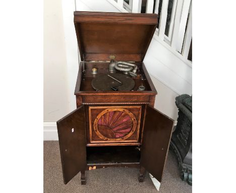 An oak gramophone produce by The Vokal, sunbeam speaker cover, and a collection of 78 rpm records.