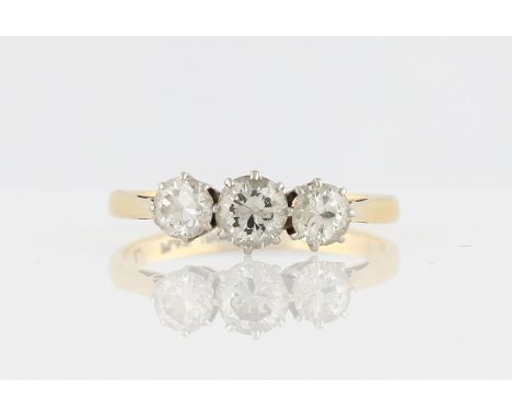 A three stone diamond ring, set with three graduated round brilliant cut diamonds, total diamond weight approx. 0.95ct, stamp