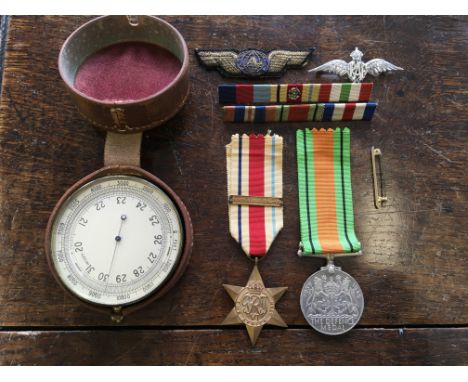Two medals to include a North African star and The Defense Medal, a 9ct gold tie pin and a barometer inscribed to back A.M. b