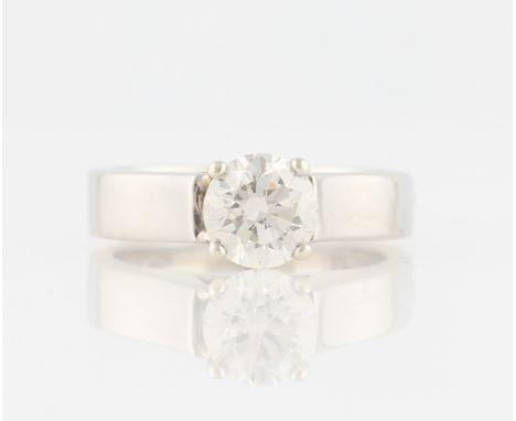 A diamond solitaire ring, set with a round brilliant cut diamond, measuring approx. 1.22ct, with raised shoulders, indistinct