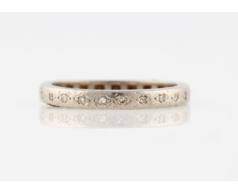 A diamond full eternity ring, set with eight cut diamond accents, unmarked white metal, ring size O.