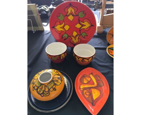 A selection of various Poole pottery to include two bowls, a large plate, two serving dishes and a vase.