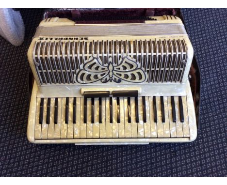 A Scandalli accordion, butterfly model, with mother of pearl finish, together with case and music book.