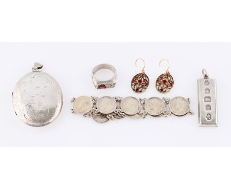 A collection of hallmarked silver jewellery, to include a locket, an ingot, a garnet ring, together with a threepence coin br