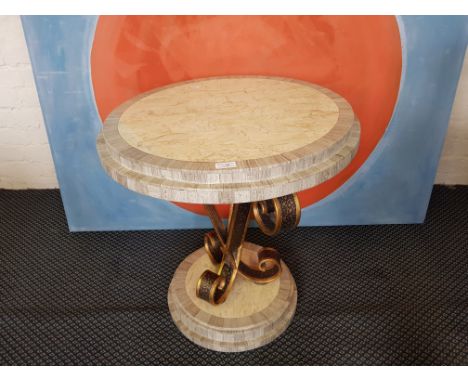 A beige and grey marble two tier round lamp table with cast iron scroll support and matching lamp with shade.