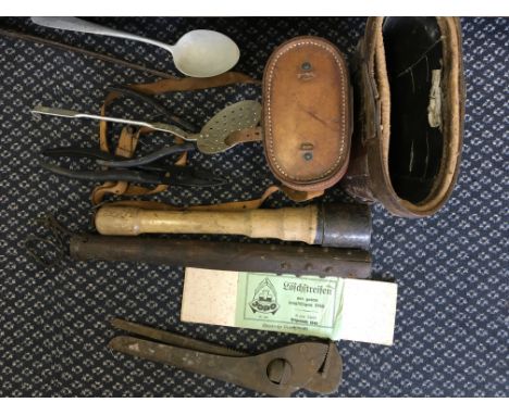 A collection of military items to include a German club, a pair of binoculars in case, a leather binoculars case, tools etc.