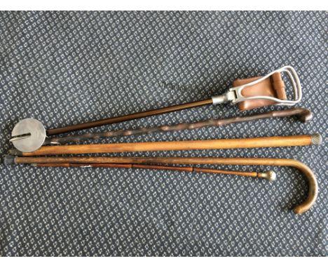 A silver topped walking cane, together with a bamboo swagger stick, a shooting stick, a traditional walking stick and one oth