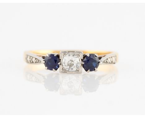 A sapphire and diamond three stone ring, set with a central transitional cut diamond, measuring approx. 0.20ct, flanked to ei