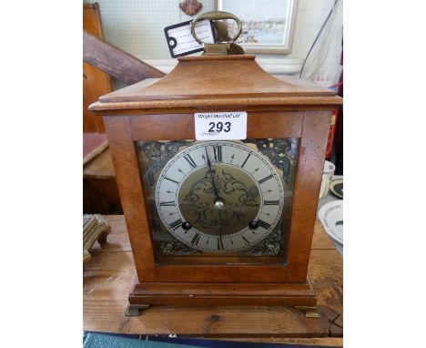 An early 20th Century walnut cased bracket clock, having a silvered bezel and applied openwork spandrels with a movement stri