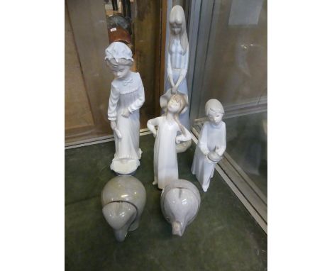 Three assorted Lladro and Nao figurines to include a similar example and two Wedgwood glass elephant paperweights