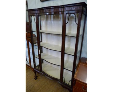 An Edwardian mahogany Chinese Chippendale revival display cabinet with a blind fret work frieze above a single concave glazed