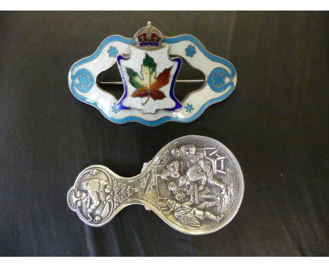 A white metal probably Dutch silver caddy spoon having repousse decoration depicting a tavern scene together with a sterling 