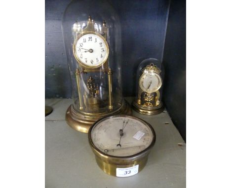 A mixed lot comprising a 20th Century brass torsion mantel clock, under perspex dome, together with a further smaller example