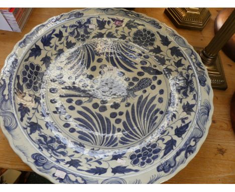 A large Chinese blue and white ceramic charger, decorated with a stylised animal, bears six character mark to base.