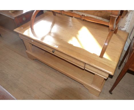 A French light oak coffee table with a single frieze drawer and under shelf.