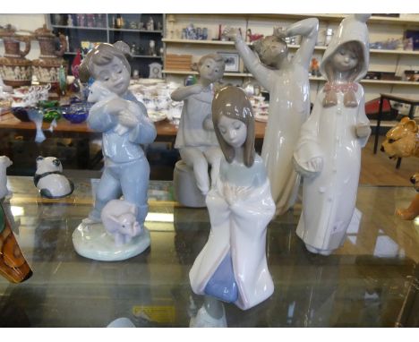 Four Lladro and Nao figurines depicting children together with a further Spanish figurine 