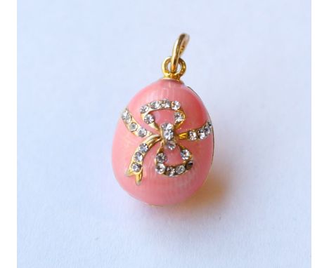 PINK ENAMEL EGG CHARM 
with rhinestone decoration in the form of a bow, the ring marked 'F.E.'