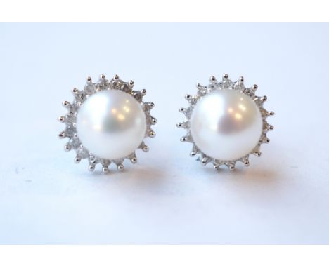 PAIR OF DIAMOND AND PEARL STUD EARRINGS
the central pearl on each in diamond surround, in all the diamonds totalling approxim