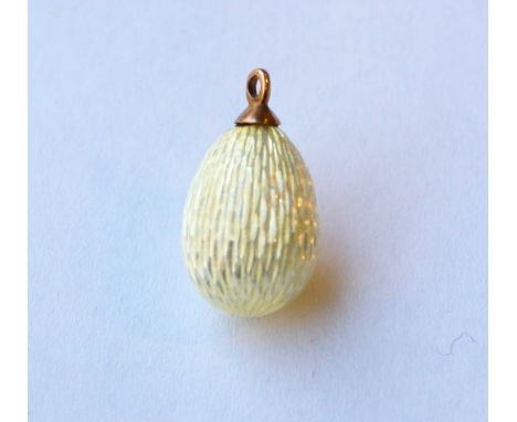 RUSSIAN ENGINE TURNED ENAMEL DECORATED EGG CHARM
in yellow, with unmarked gold ring