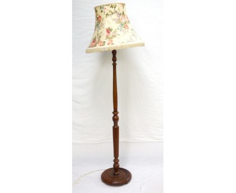 1930's OAK FLOOR LAMP
with shaped column, on circular base raised on bun feet, with floral shade