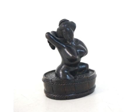 CARVED WOODEN NETSUKE
modelled as a bathing Geisha, inset signature to base, 4.8cm high