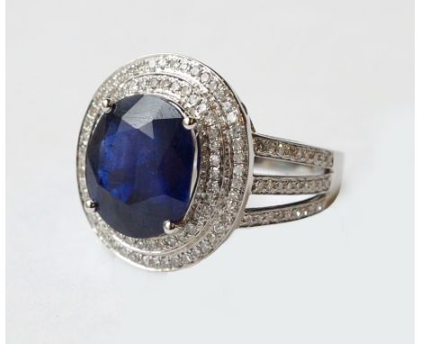 IMPRESSIVE SAPPHIRE AND DIAMOND CLUSTER RING
on eighteen carat white gold shank, the central oval cut sapphire approximately 