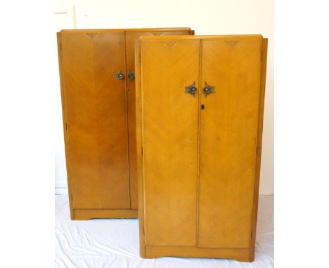 TWO MATCHING 1950's OAK VENEERED WARDROBES
by 'Heathland Furniture', both two-door, the larger fitted with interior upper she