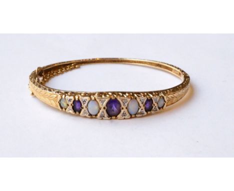 AMETHYST, DIAMOND AND OPAL SET NINE CARAT GOLD BANGLE
with engraved and scroll decoration to the bangle, with safety chain