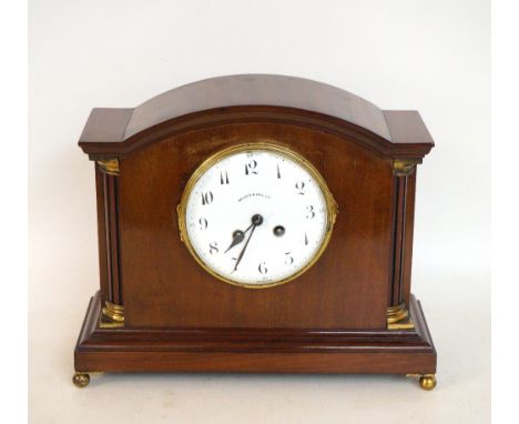 MAHOGANY EIGHT DAY ARCHED MANTLE CLOCK
with a circular enamel dial marked Walker & Hall Ltd. flanked by pillars with gilt met