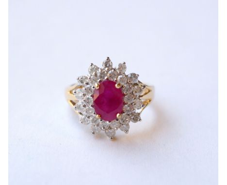 RUBY AND DIAMOND CLUSTER DRESS RING
the central ruby approximately 1.3cts, in double diamond surround totalling approximately