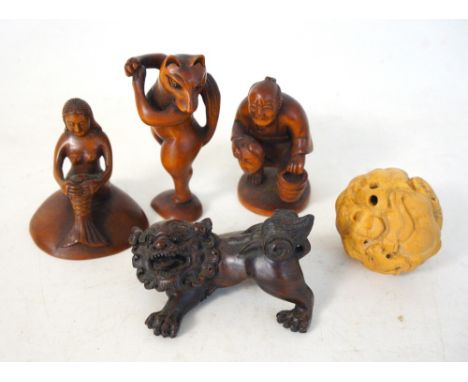 FIVE JAPANESE HARDWOOD CARVED NETSUKE
depicting entwined water buffalo, a peasant holding a bucket, a foo dog, a dancing fox 