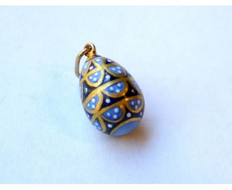 DECORATIVE RUSSIAN ENAMELLED EGG CHARM
in light and dark blue with gilt highlights, with Cyrillic makers mark to the silver g