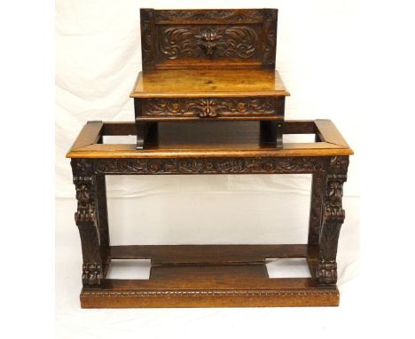 VICTORIAN OAK HALL STAND
now reduced in height, with a carved raised back with a shelf below with a carved lion mask handle, 