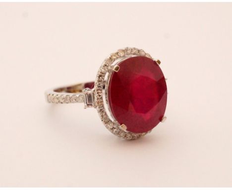 IMPRESSIVE RUBY AND DIAMOND CLUSTER RING
the central oval cut ruby approximately 7cts in diamond surround and with further di