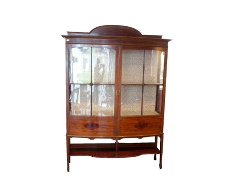 EDWARDIAN MAHOGANY AND INLAID BOW FRONT DISPLAY CABINET
with a shaped raised back above a moulded cornice, with a pair of pan