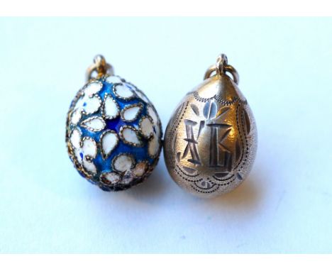 TWO RUSSIAN EGG CHARMS
one silver gilt example with engraved decoration and indistinct marks; the other with colourful enamel