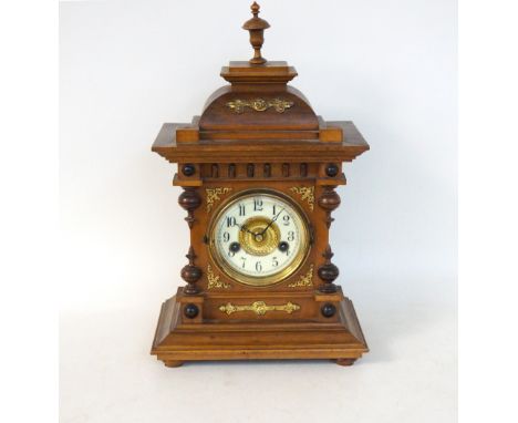 EARLY 20th CENTURY WALNUT MANTLE CLOCK
with an eight day movement, the case with gilt metal decoration and standing on flatte