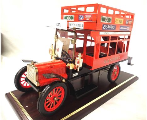 Tinplate model of vintage bus General Red, approximately 40 cm, on wooden plinth, boxed. P&amp;P Group 2 (£18+VAT for the fir