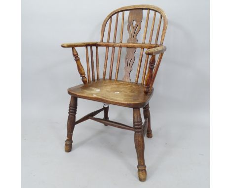 An Antique oak and elm-seated comb-back kitchen chair 