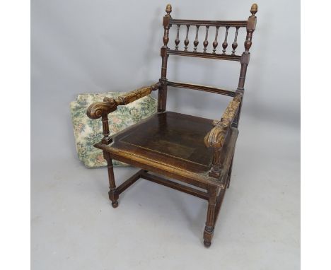 An Antique oak open armchair, with bobbin turned back and carved decoration 