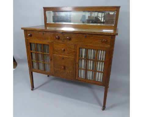 R J Horner, an American Arts and Crafts Mission sideboard, with glazed doors and mirror-back in tiger oak, with R J Horner & 