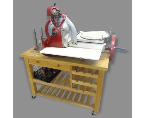 A Berkel & Parnall's manual meat slicing machine, mounted on a butcher's block, overall 137 x 154 x 77cm 