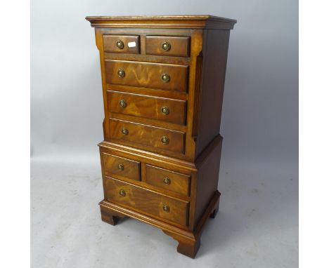 A reproduction mahogany miniature chest on chest in 1 section, having 8 fitted drawers, on bracket feet, 41 x 76 x 30cm 