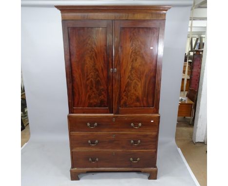 A 19th century mahogany 3-section linen press, having rail fitted interior, with 3 long drawers below, on bracket feet, 115cm