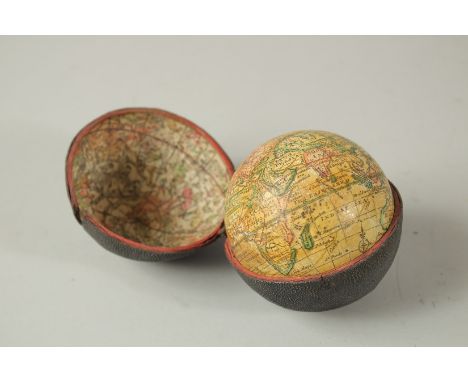 A GLOBE with the new discoveries. 7cms dial, in a folding shagreen case.