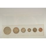 SIX AMERICAN SILVER COINS in a perspex case.