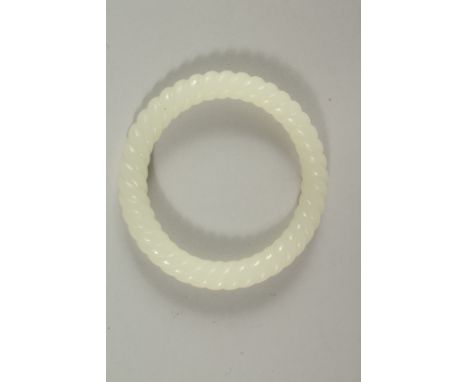 A CHINESE WHITE JADE TWIST BANGLE. 8cms diameter.