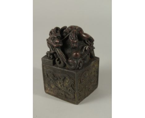 A CHINESE BRONZE DRAGON SEAL. 12cms high.