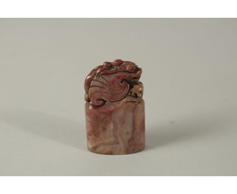 A CHINESE CARVED HARDSTONE DRAGON SEAL. 8cms high.