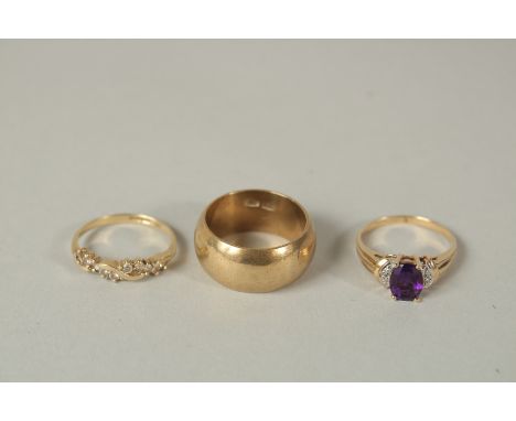 A .750 GOLD WEDDING RING AND TWO OTHER RINGS.
